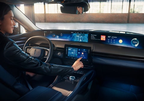 The driver of a 2024 Lincoln Nautilus® SUV interacts with the center touchscreen. | Empire Lincoln in Abingdon VA